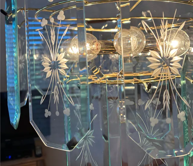 After: The same chandelier, the etched glass panels clear and bright.