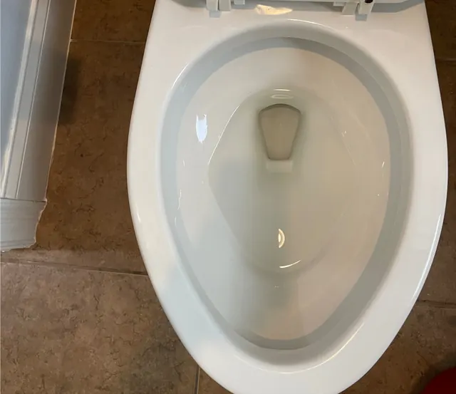 After: The same toilet bowl, white and clean.